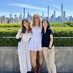 Arianne See and friends with the New York skyline